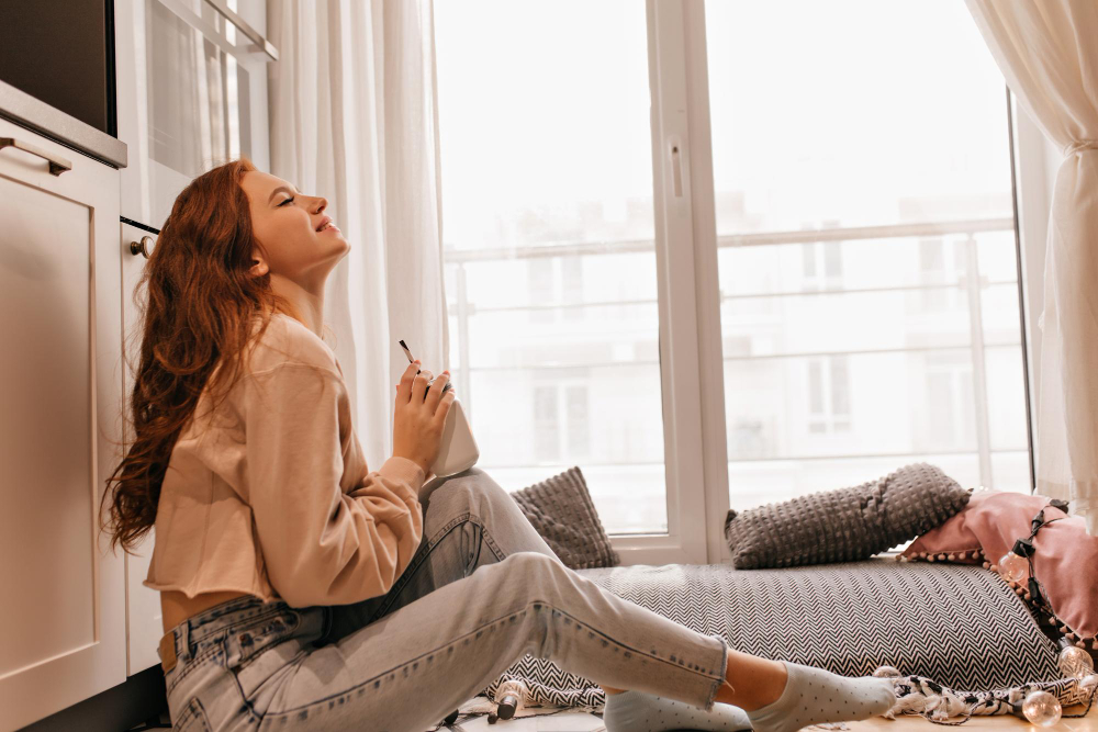 cheerful girl drinking tea her cozy room positive female model with ginger hair enjoying mulled wine