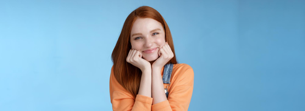 tenderness wellbeing beauty conept attractive young ginger girl pure skin blue eyes lean palms silly